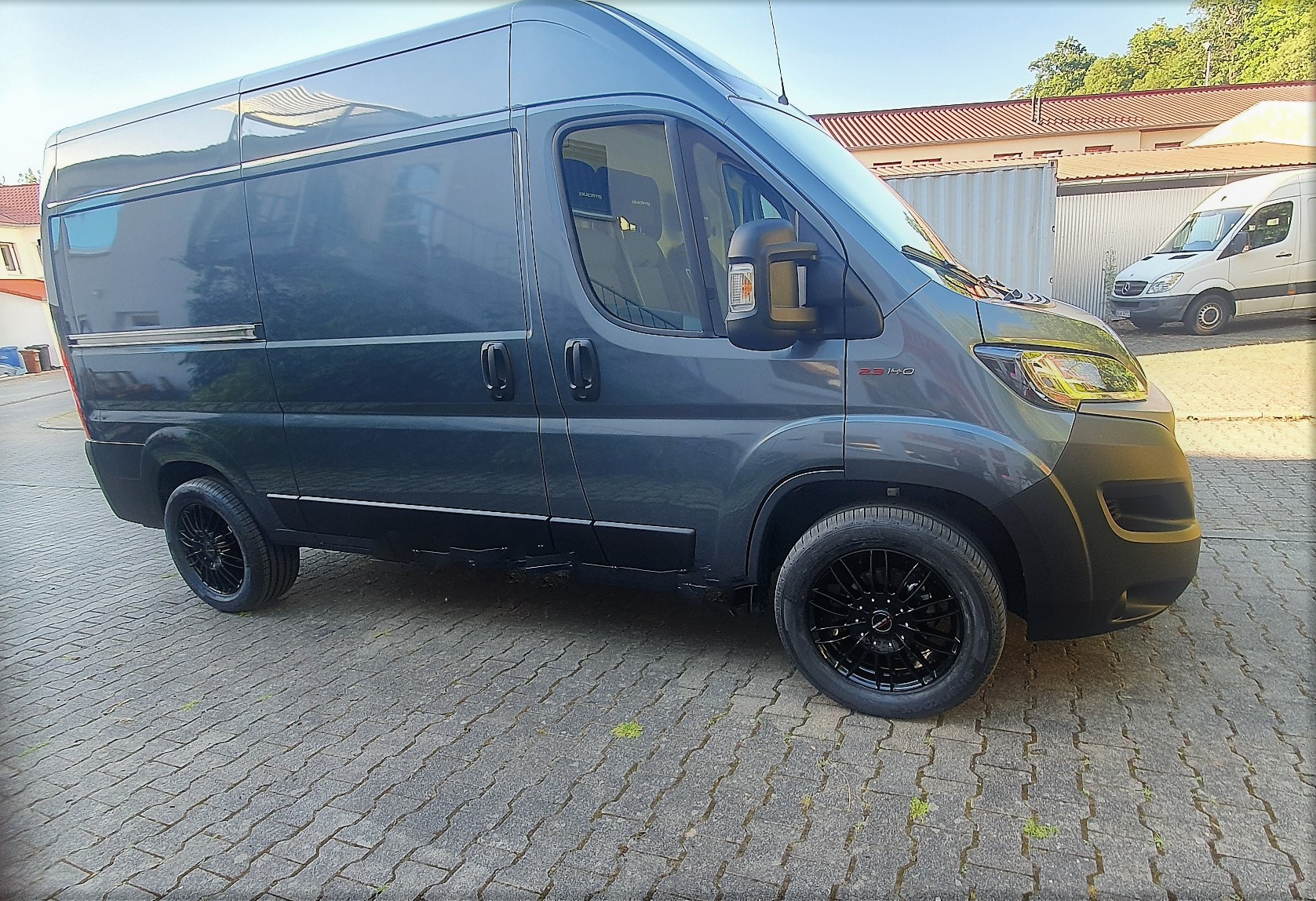 Blauer Transporter der für den Hol- und Bringdienst von V2 Mastercraft 